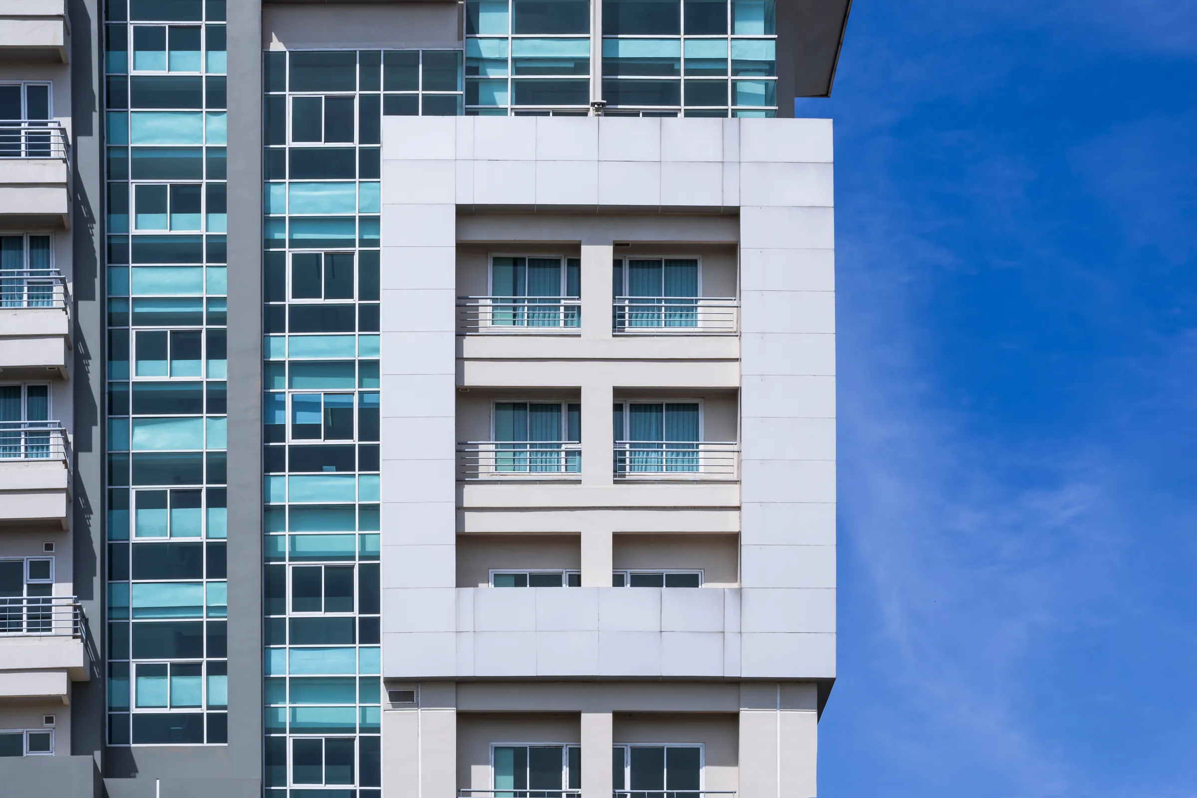 Edificio moderno con aberturas de aluminio contra un cielo azul